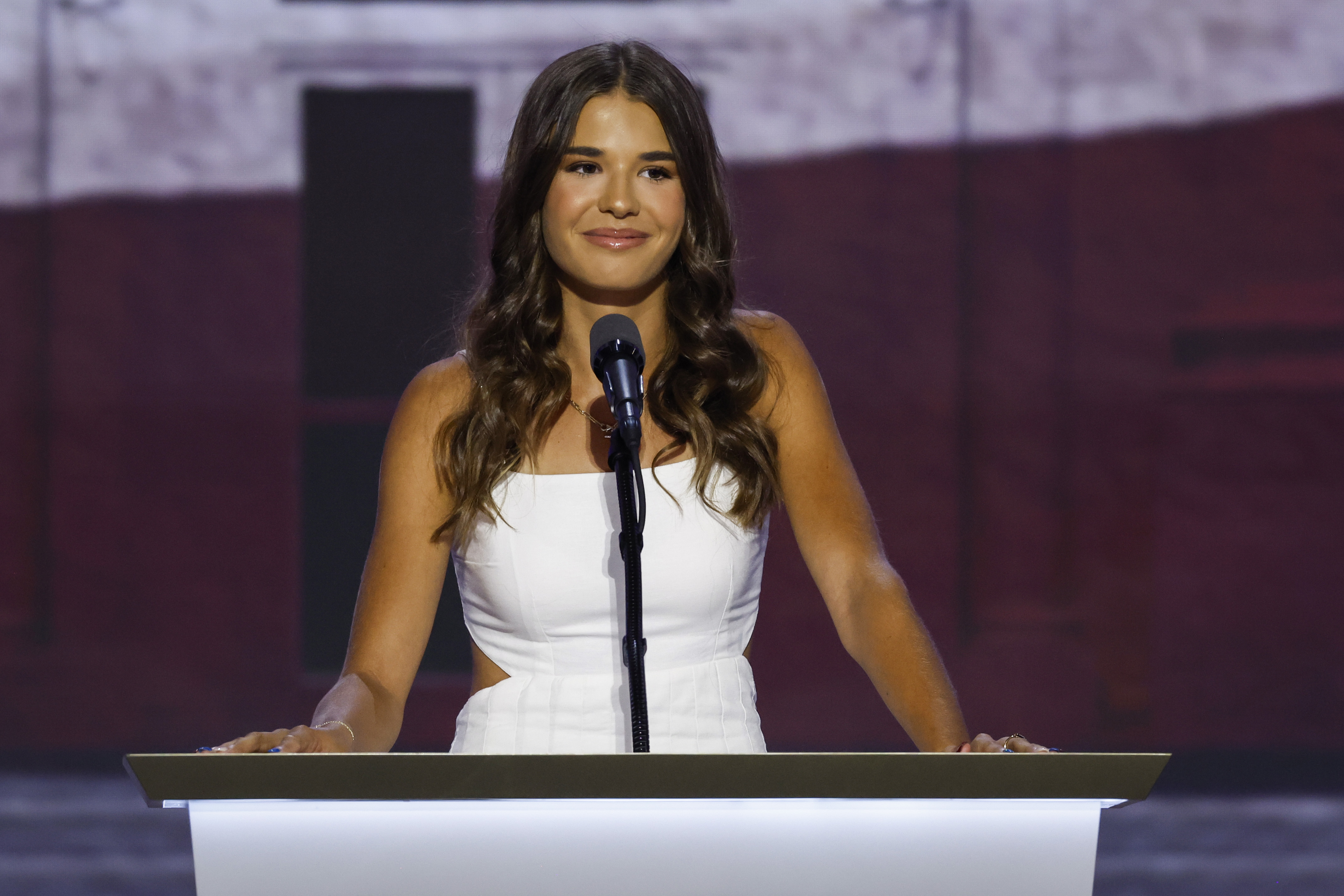 Kai Trump appeared this event with a sun-kissed tan and noticeably darker hair than she displayed in her earlier years. In this photo, she can be seen speaking on stage on the third day of the Republican National Convention at the Fiserv Forum on July 17, 2024, in Milwaukee, Wisconsin.