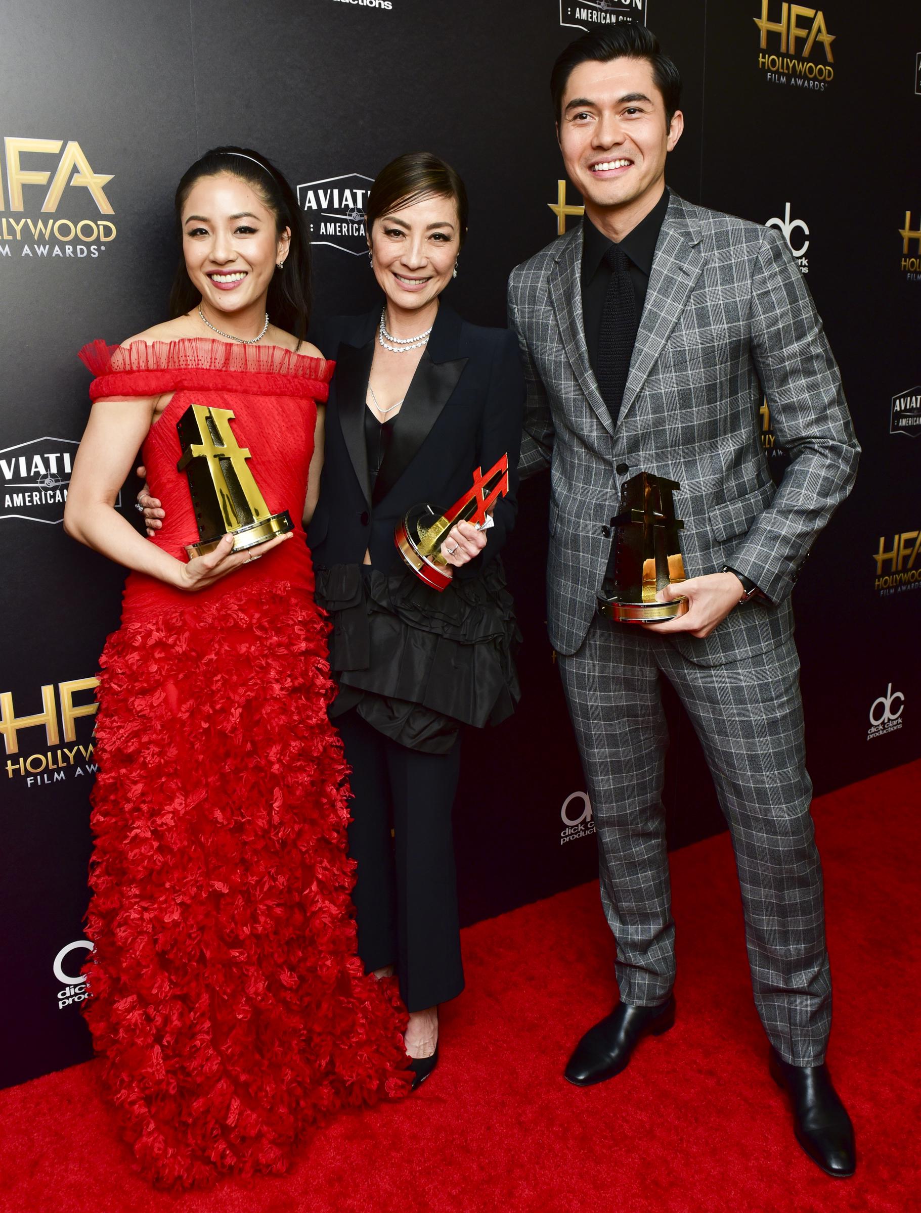 Constance Wu, Michelle Yeoh, and Henry Golding, recipients of the Hollywood Breakout Ensemble Award for "Crazy Rich Asians," pose in the press room at the 22nd Annual Hollywood Film Awards on November 4, 2018 | Source: Getty Images