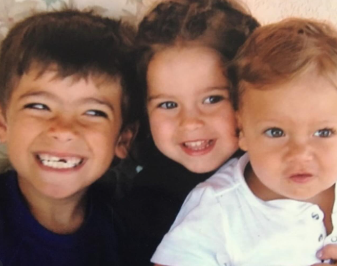 This early photo shows Kelly Ripa and Mark Consuelos' three children during their younger years. Long before their careers, graduations, and public milestones, family photos like this documented everyday moments shared between the siblings. | Source: Instagram/kellyripa