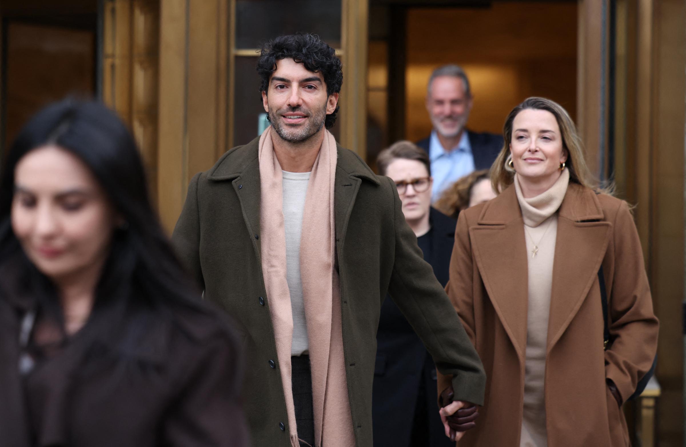 Justin Baldoni leaves federal court holding hands with his wife Emily Baldoni following a court-ordered settlement conference in his ongoing legal dispute with actress Blake Lively related to the film "It Ends With Us," in New York on February 11, 2026. | Source: Getty Images