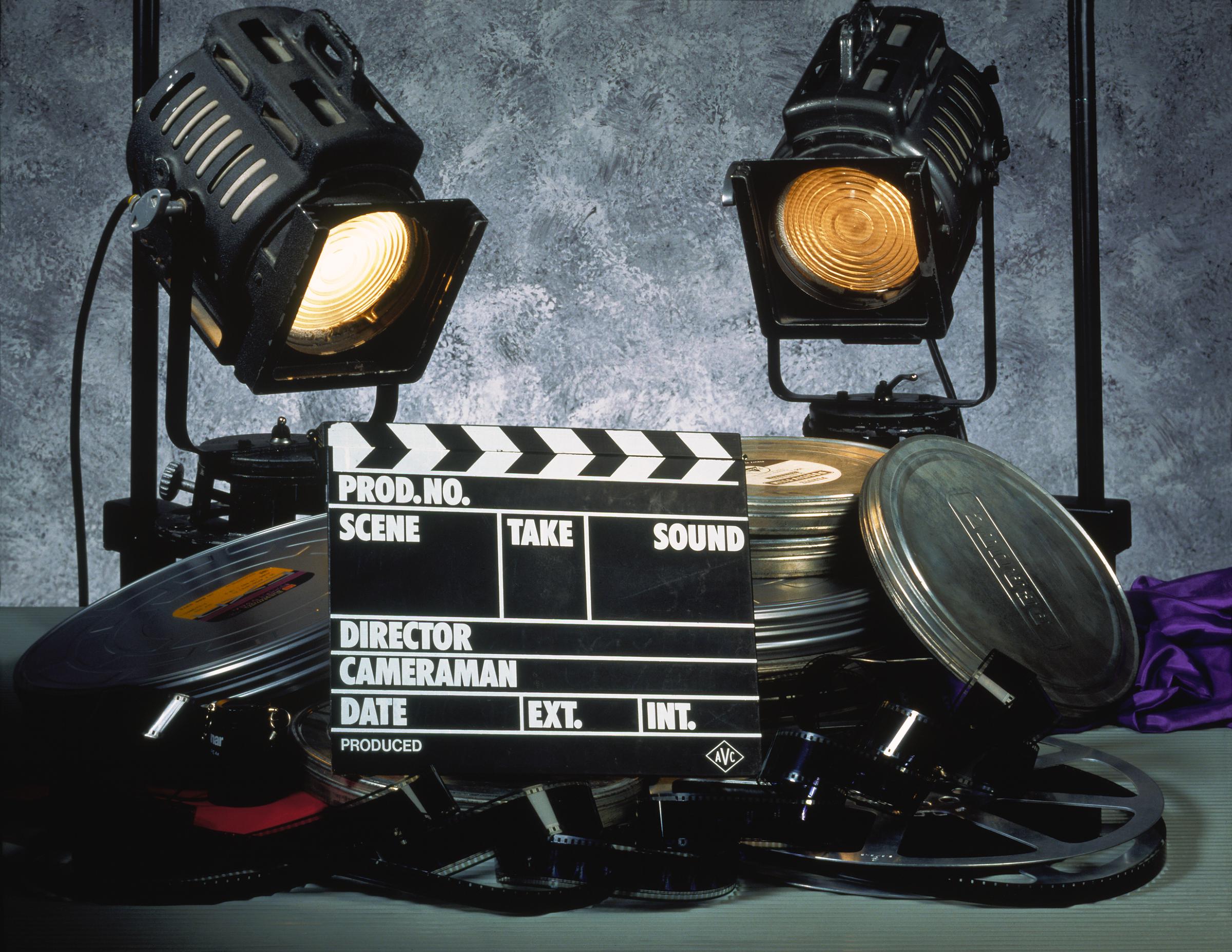 A clapperboard, film, and two floodlights | Source: Getty Images