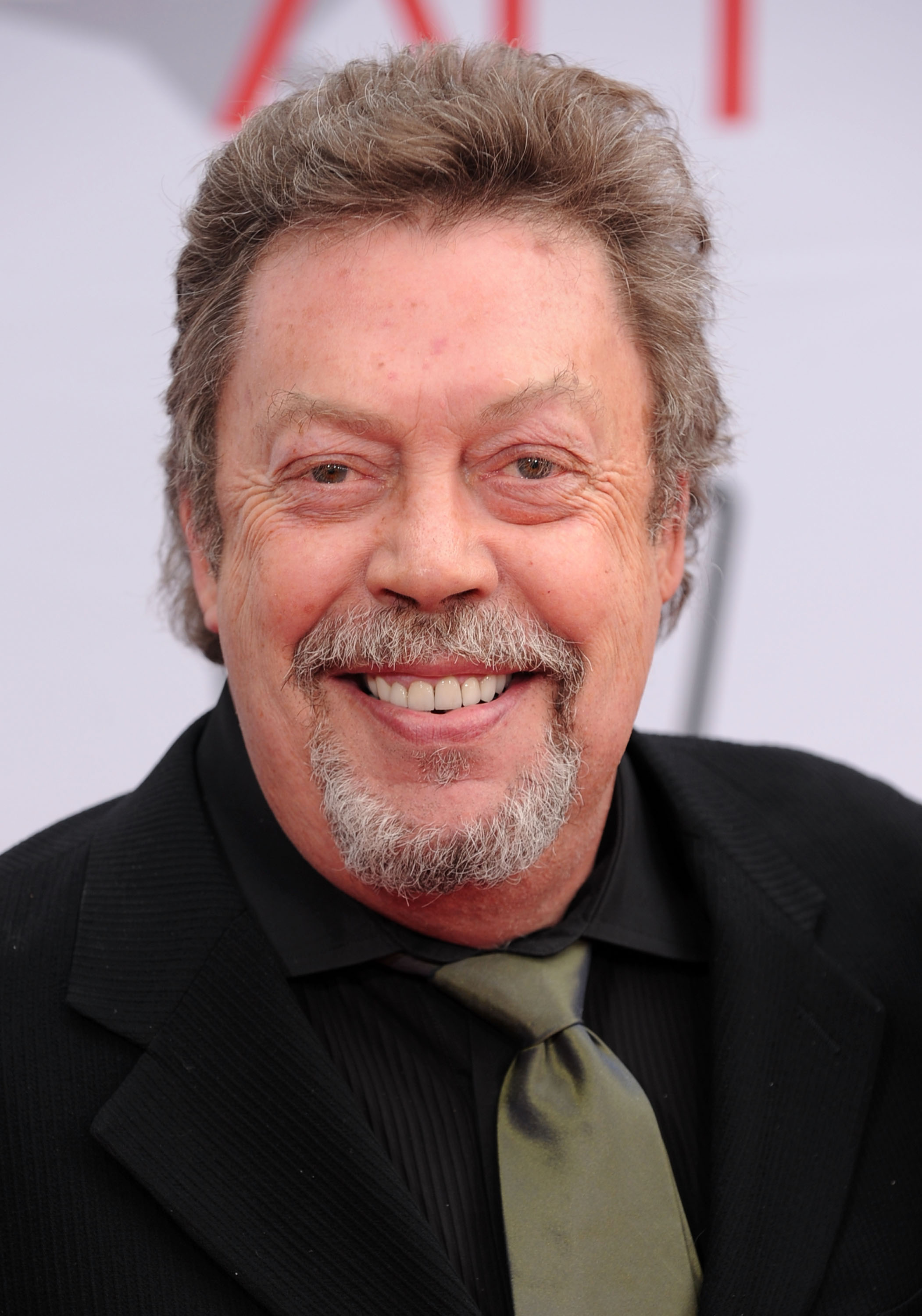 Tim Curry arrives at the 38th AFI Life Achievement Award honoring Mike Nichols held at Sony Pictures Studios on June 10, 2010 in Culver City, California. | Source: Getty Images