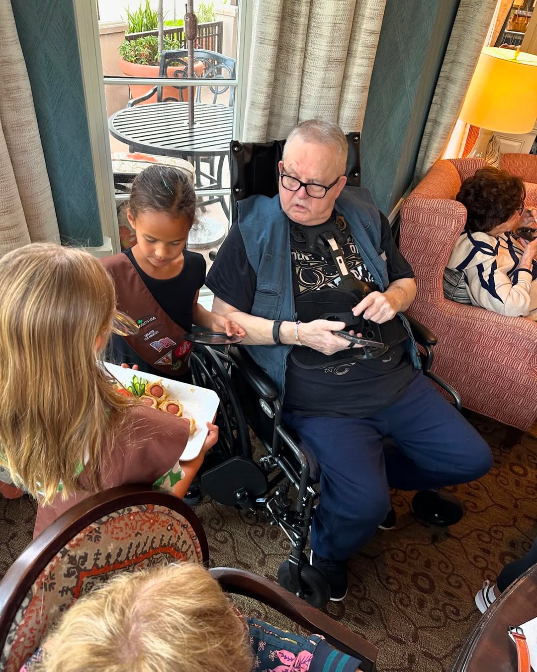 Ron Teigen is seen with his grandchildren inside his assisted-living home in a photo shared on April 25, 2024. | Source: Instagram/chrissyteigen