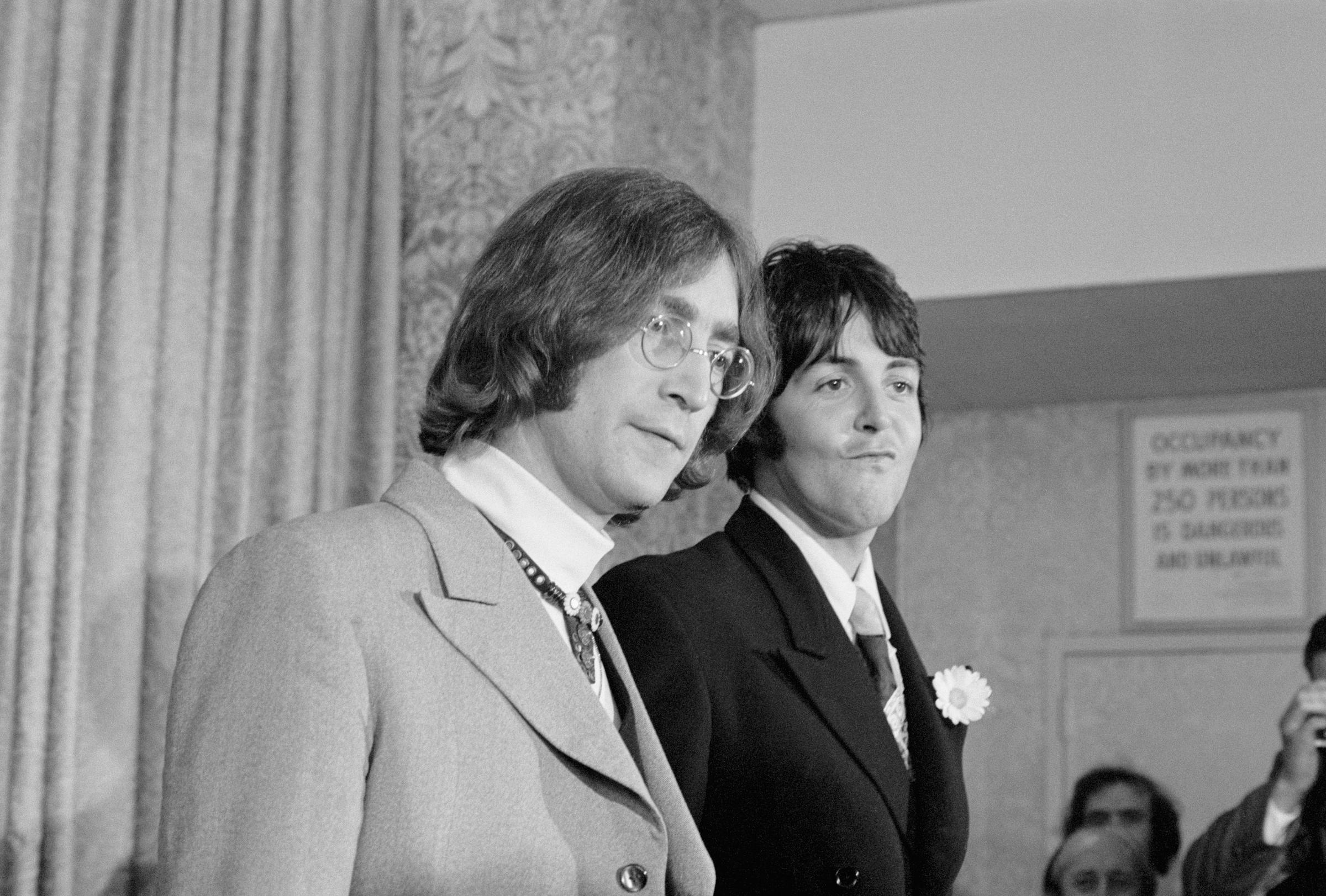John Lennon (left) and Paul McCartney during a press conference on May 14, 1968, to announce the establishment of an organization to serve as a catchall of the entertainment business. | Source: Getty Images