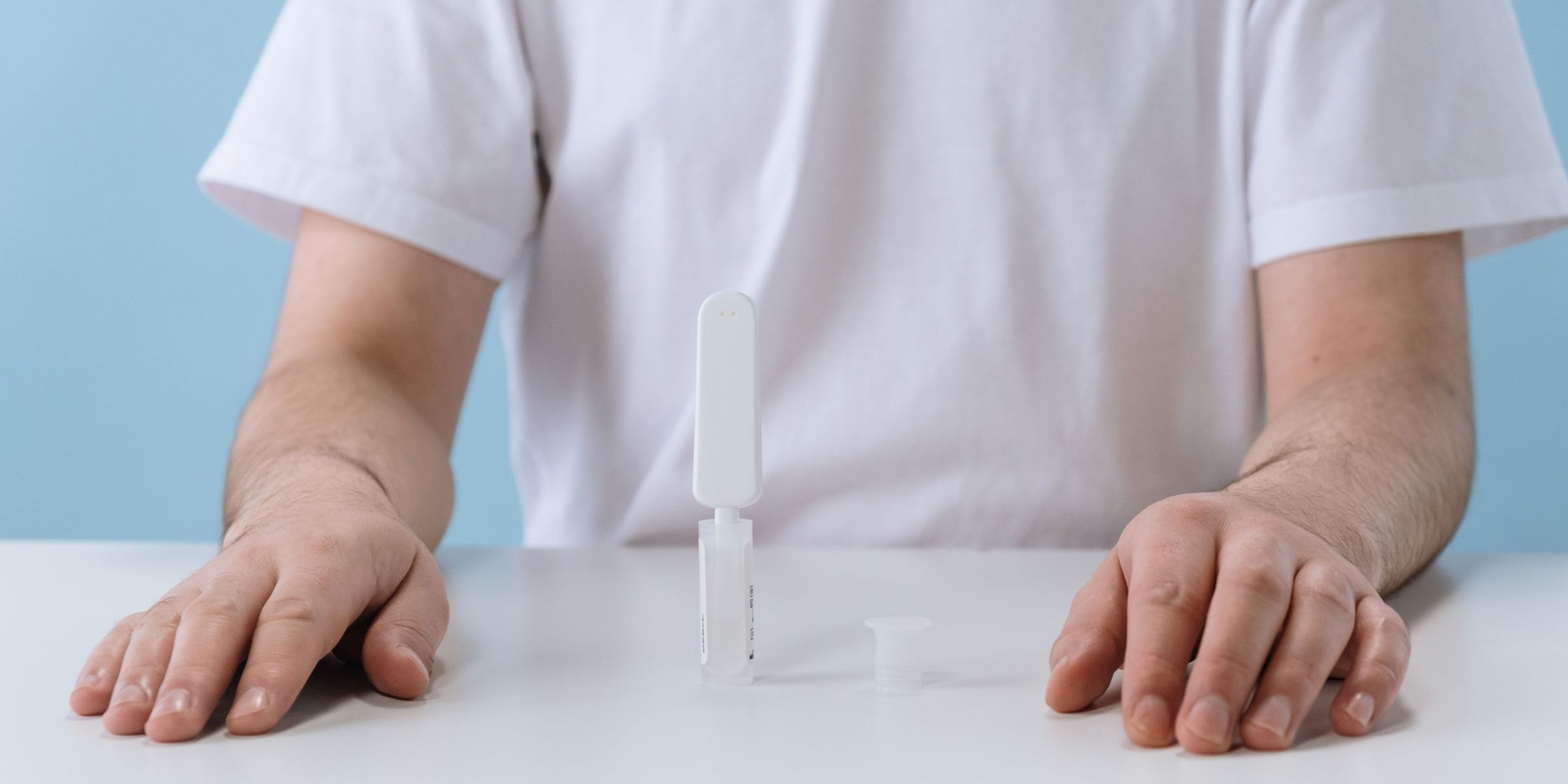 A person sitting with a DNA test in front of them | Source: Pexels