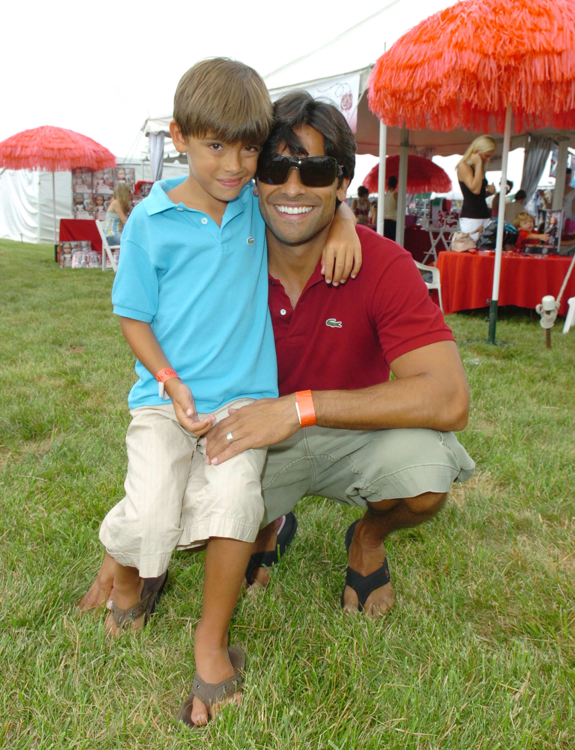 Michael Consuelos poses with his father, Mark Consuelos, at a public event during his childhood. Family photos from this period later became part of the side-by-side comparisons that many fans referenced online. | Source: Getty Images
