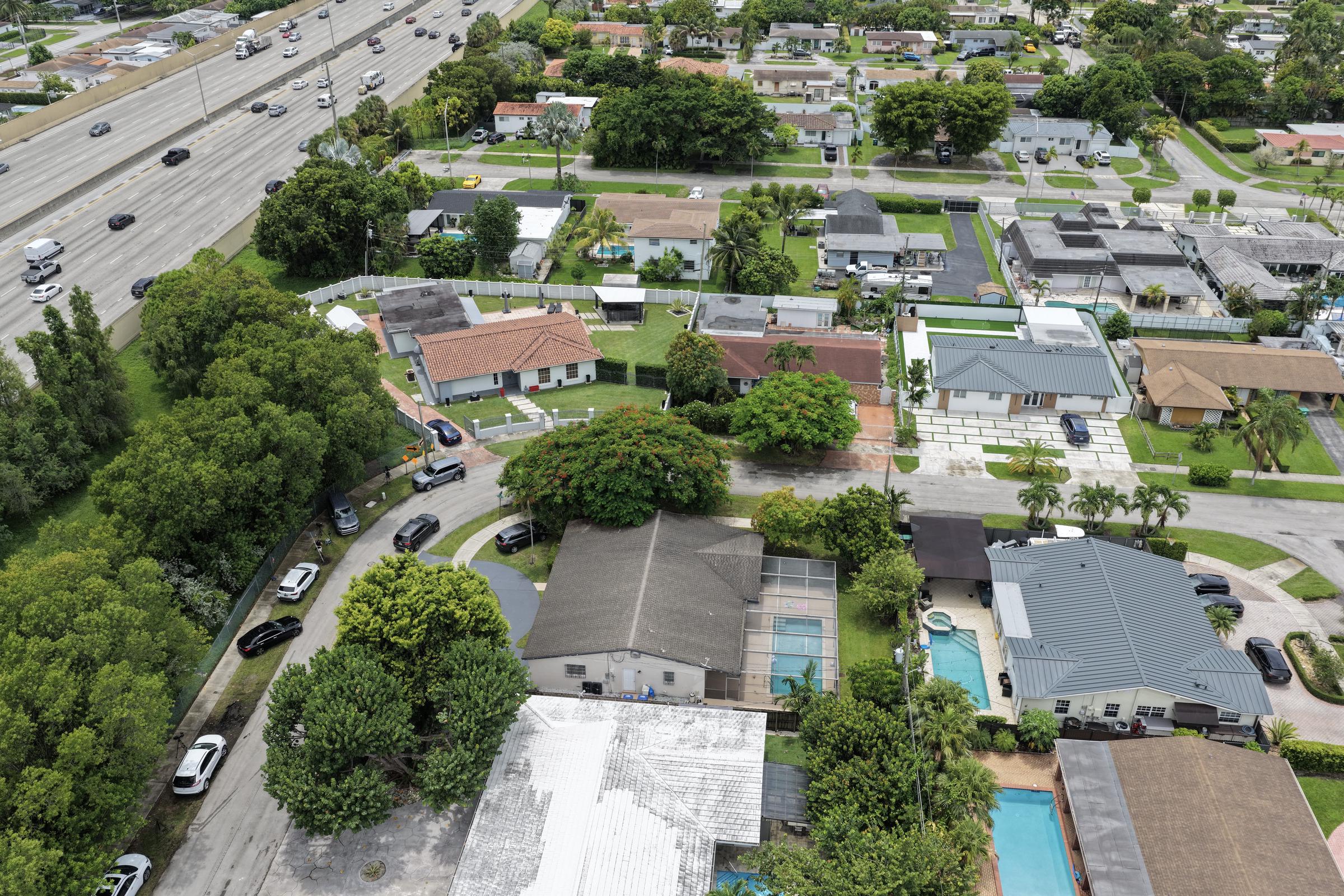 In an aerial view, the home (with gray roof and pool bottom L) where Perez Hilton was found after he appeared to harm himself during a TikTok livestream on August 5, 2026, in Westchester, Florida. | Source: Getty Images