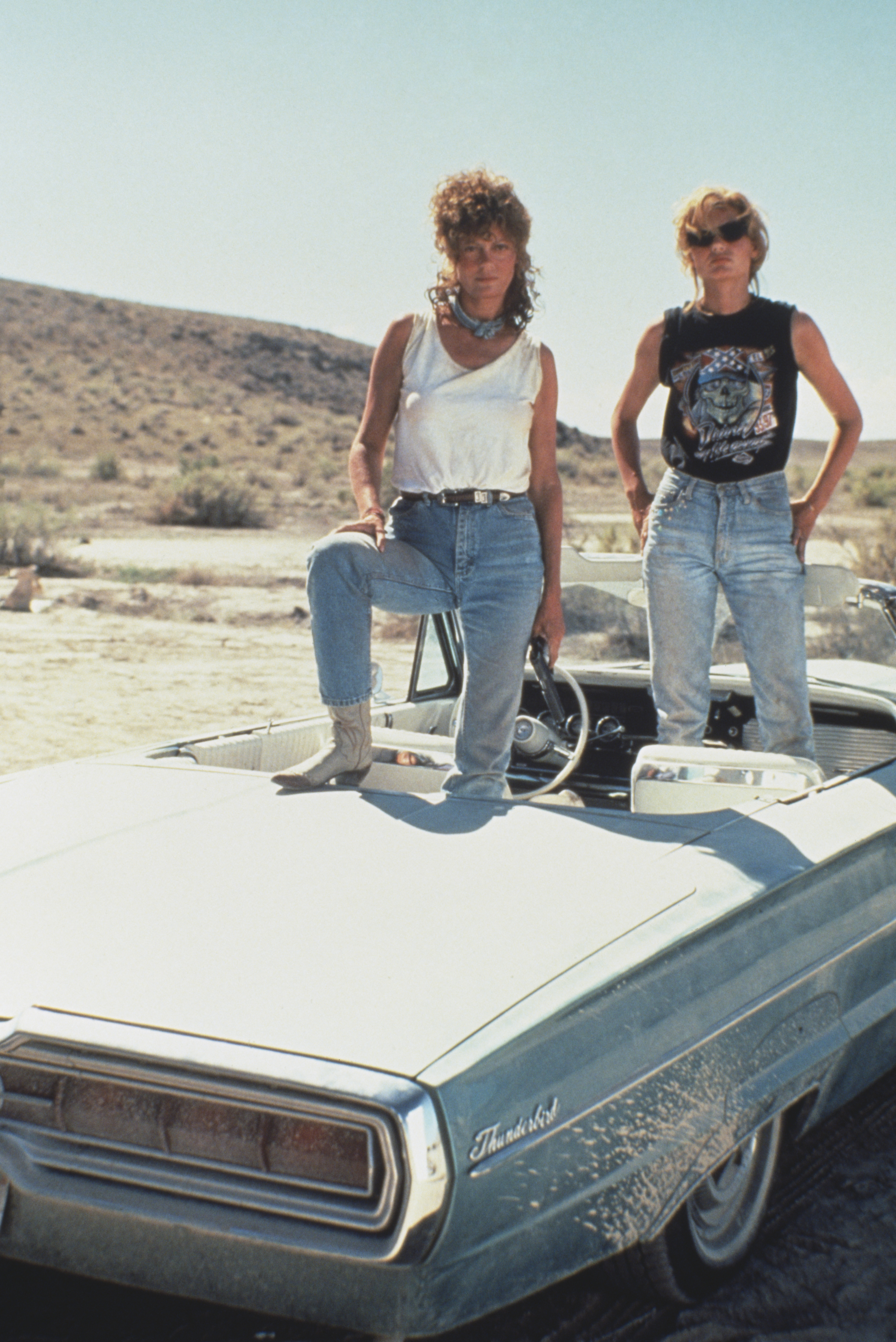 Susan Sarandon (left) and Geena Davis pose on their 1966 Ford Thunderbird for the film "Thelma And Louise," 1991. | Source: Getty Images