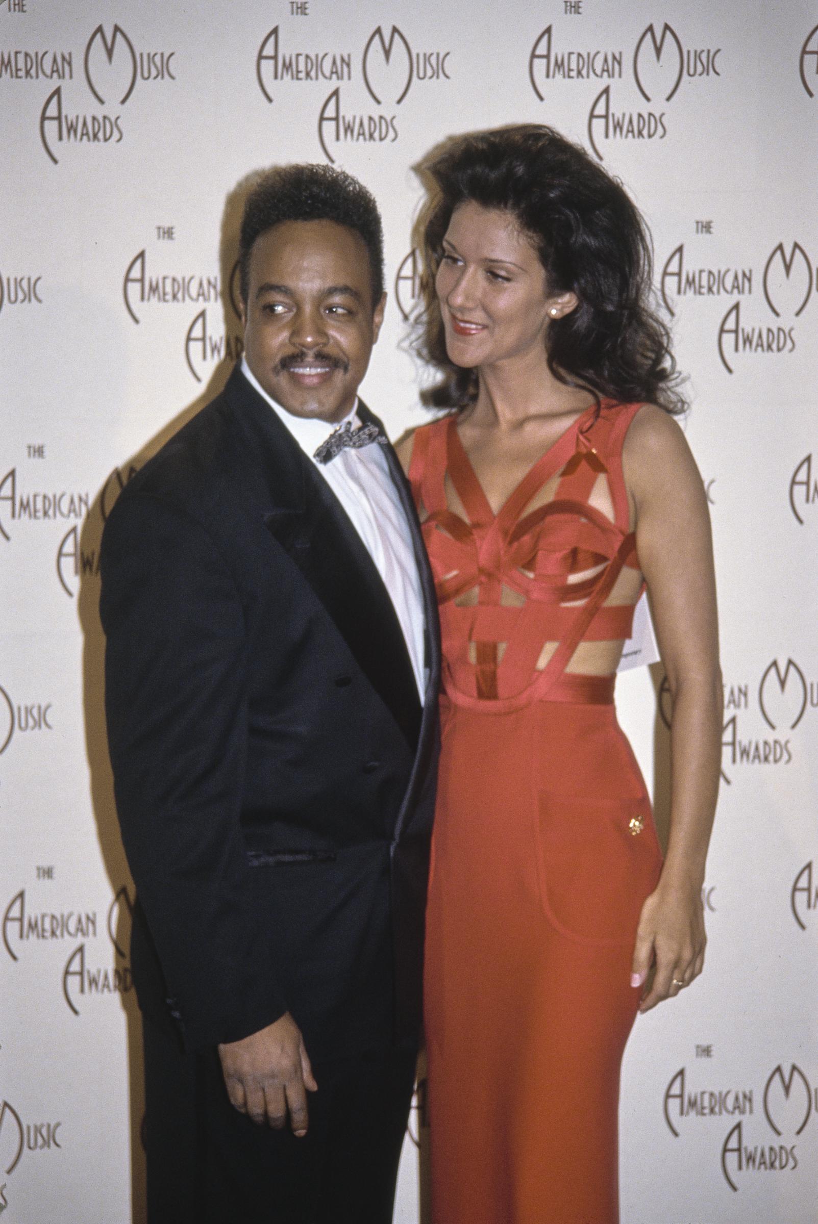 The late singer and songwriter was best known for his iconic contributions to Disney soundtracks, including "Beauty and the Beast". At this event, he and Canadian singer Celine Dion posed in the press room at the Shrine Auditorium on January 25, 1993, in Los Angeles, California | Source: Getty Images